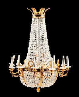 An Empire Style Gilt and Patinated Bronze Twelve-Light Chandelier Height 46 x diameter 35 inches.