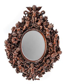 An Italian Renaissance Revival Carved Walnut Mirror Height 61 x width 45 inches.