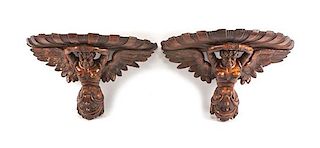 A Pair of Continental Carved Figural Brackets Height 16 x width 26 x depth 11 inches.