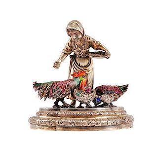 A Continental Ruby Mounted Silver and Enamel Figure, , in the form of a peasant woman feeding three birds.