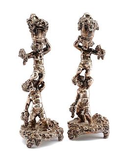 A Pair of Silver Figural Candlesticks, Circa 2000, each in the form of two Bacchanalian putti supporting a bushel of grape bunch