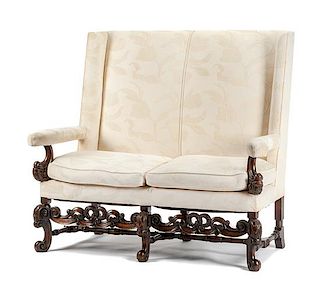 A Jacobean Revival Settee Height 51 x width 57 x depth 29 inches.