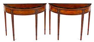 A Pair of George III Mahogany Demilune Tables Height 32 x width 40 1/2 x depth 16 1/2 inches.