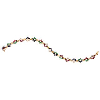 A sapphire, emerald, ruby and diamond 18K yellow gold bracelet.