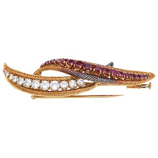 A ruby and diamond 18K yellow gold brooch.