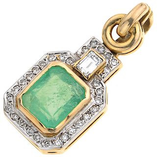 An emerald and diamond 14K yellow gold pendant.
