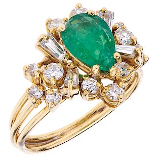 An emerald and diamond 18K yellow gold ring.