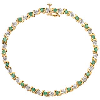 An emerald and diamond 14K yellow gold bracelet.