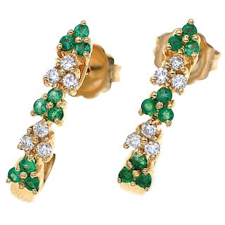 An emerald and diamond 14K yellow gold pair of earrings.
