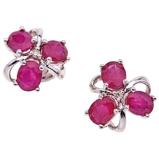 A ruby and diamond 18K white gold pair of stud earrings.