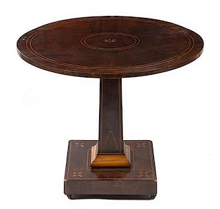 A Continental Mahogany Center Table, Height 26 1/4 x diameter 31 1/2 inches.