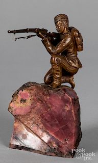Patinated bronze figure with a rifle