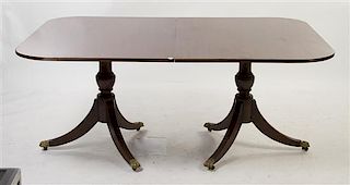 A Regency Style Mahogany Double Pedestal Table, Height 29 1/2 x width 67 x depth 47 1/4 inches (closed).
