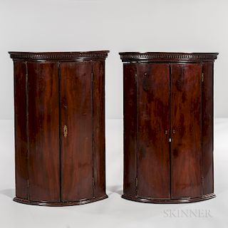 Pair of George III Mahogany and Mahogany-veneered Hanging Bow-front Corner Cabinets