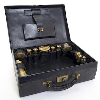 A Cased Gilt Metal Dressing Set, Width of case 16 5/8 inches.