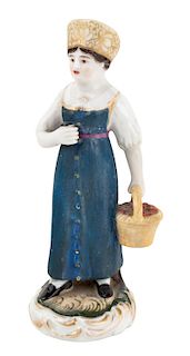 A RUSSIAN PORCELAIN FIGURE OF A PEASANT GIRL WITH A BASKET OF BERRIES, GARDNER PORCELAIN FACTORY, MOSCOW, 1830S