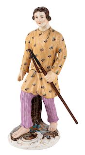 A RUSSIAN PORCELAIN FIGURE OF A YOUNG MAN WITH A WALKING STICK, POPOV PORCELAIN FACTORY, MID-19TH CENTURY