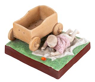 A RUSSIAN PORCELAIN FIGURE OF A BABY WITH A CART, GARDNER PORCELAIN FACTORY, MOSCOW, LATE 19TH CENTURY