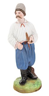A RUSSIAN PORCELAIN FIGURE OF A MALOROSS WITH A PIPE, FROM THE "PEOPLE OF RUSSIA" SERIES, GARDNER PORCELAIN FACTORY, MOSCOW, LATE 19TH CENTURY