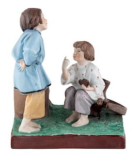A RUSSIAN PORCELAIN FIGURAL GROUP OF PEASANT BOYS ARGUING OVER A BROKEN WHEEL, GARDNER PORCELAIN FACTORY, MOSCOW, LATE 19TH CENTURY