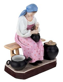 A RUSSIAN PORCELAIN FIGURE OF A PEASANT WOMAN COOKING, GARDNER PORCELAIN FACTORY, MOSCOW, LATE 19TH CENTURY