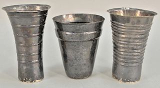 Peruvian silver three tall cups. ht. 6 in., 6 3/4 in., & 7 in., 19.6 t oz. 
Provenance: Estate of Kenneth Jay Lane