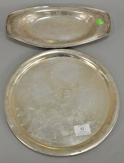 Two sterling silver trays. lg. 13 1/4 in., & dia. 12 in., 28.4 total t oz. 
Provenance: Estate of Kenneth Jay Lane