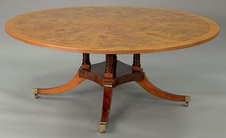 Round pedestal dining table with pads. ht. 29 in., dia. 72 in.