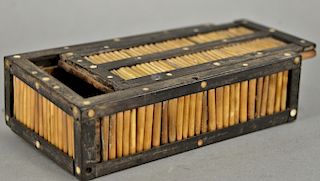 Wood and porcupine quill casket, decorated with wood borders and bone roundels at intervals with slide top. ht. 2 in., lg. 7 in. 
Pr...