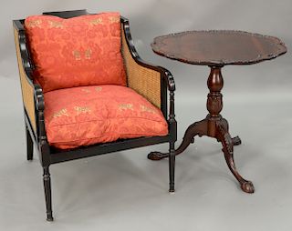 Two piece lot to include a Swaim armchair with caned sides and back and a mahogany tip table with scalloped edge.