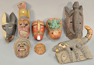 Eight wooden hand carved tribal masks to include a lizard, fox, scorpion, frog masks and three figural masks. 9 in. to 16 1/2 in. 
P...