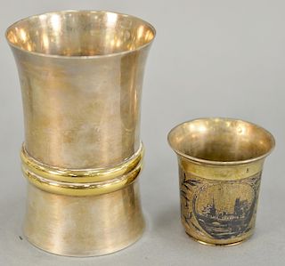 Two cups including one Jean Puiforcat with gold bands ht. 4 in. and one small Russian cup ht. 2 in., 7.9 t oz. 
Provenance: Estate o...