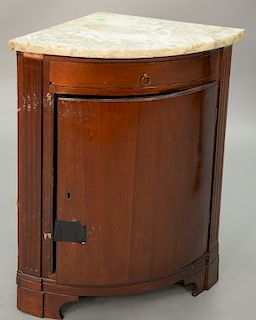 Corner mahogany marble top cabinet. ht. 31 in., dia. 18 1/2 in. 
Provenance: Estate of Kenneth Jay Lane