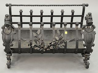 Large Victorian iron fireplace log holder with figural dog ends. ht. 18 1/2 in., wd. 28 in.