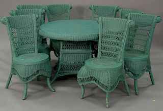 Nine piece wicker set with eight side chairs and round table with glass top (two chairs with ripped seats). ht. 29 in., dia. 44 in.