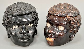 Two blackamoor cover head boxes including one brown glazed with white glazed eyes and a terracotta black glazed with white painted e...