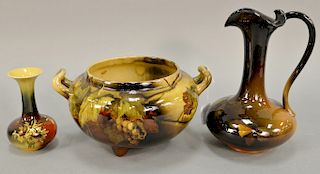 Three Rookwood glazed pottery pieces including an ewer with handle signed on bottom, ht. 9 1/2 in.; a handled bowl/pot on three feet...