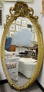 Two piece lot to include Victorian oval mirror, original gilt decoration. 71" x 36" and Louis XVI style marble top table with brass ...