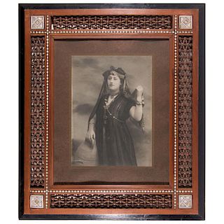 Framed photograph of a Middle Eastern woman.