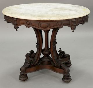 Oval Victorian walnut marble top table. ht. 28 in., top: 25" x 36"