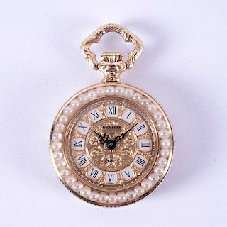 Reloj de bolsillo. Suiza, siglo XX. Mecanismo de cuarzo. De la firma Bucherer. Carátula dorada de 18 mm. con índices romanos.
