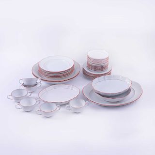 Servicio abierto de vajilla. Alemania, siglo XX. En porcelana Meissen, color blanco con bordes rojizos. Piezas: 36