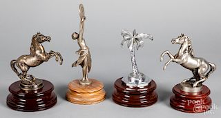 Four figural hood ornaments