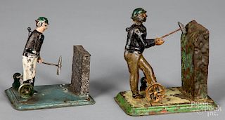 Two painted tin miner steam toy accessories