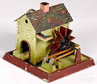 Doll & Cie painted and embossed tin mill steam toy