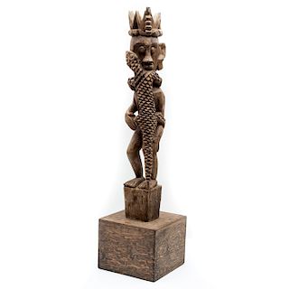 Hombre con lagarto. Kupa Bali, Indonesia, siglo XX. Talla en madera con placa. 99 x 25 x 25 cm.