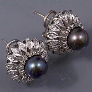 Par de aretes con perlas en plata paladio. 2 perlas tahitianas de 9 mm. 58 acentos de diamantes. Peso: 10.8g.