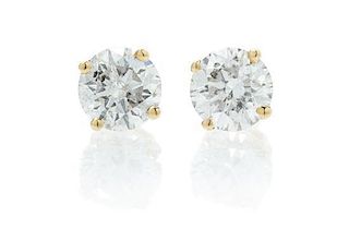 * A Pair of 14 Karat Yellow Gold and Diamond Earrings, 0.60 dwts.