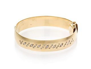 A 14 Karat Yellow Gold and Diamond Bangle Bracelet, 28.30 dwts.