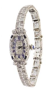 A Platinum, 14 Karat White Gold, Diamond and Synthetic Sapphire Wristwatch, Abel, 11.00 dwts.